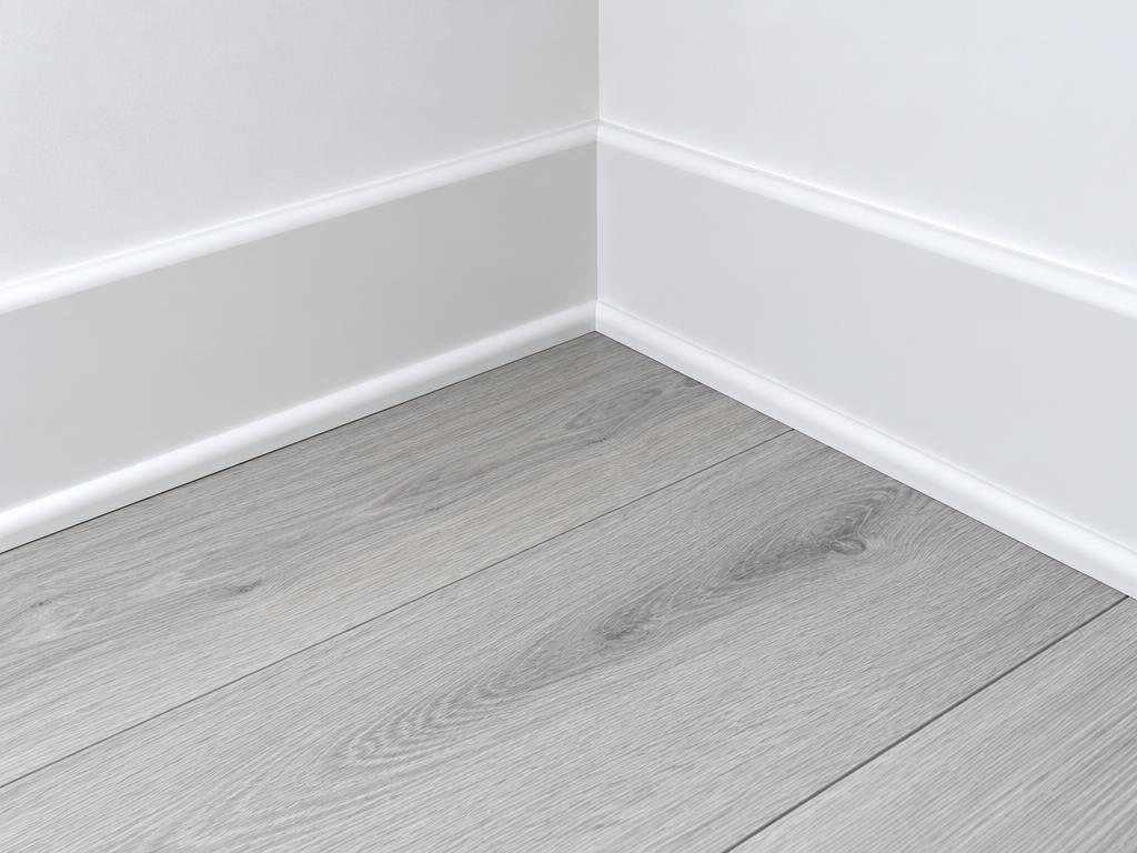 Illustration of skirting and scotia at a laminate floor edge