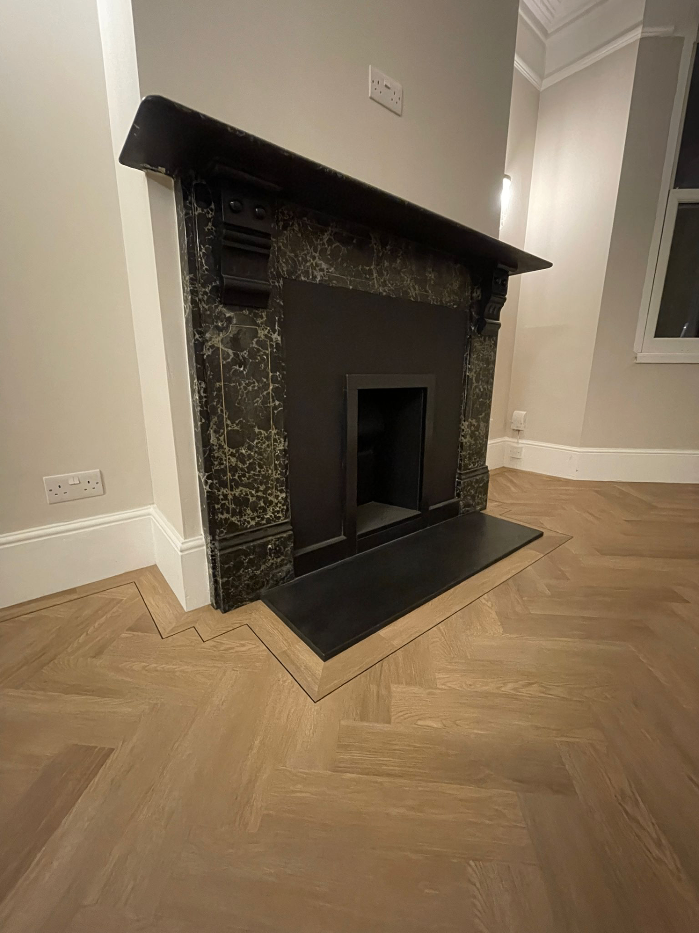 Herringbone living room with fireplace