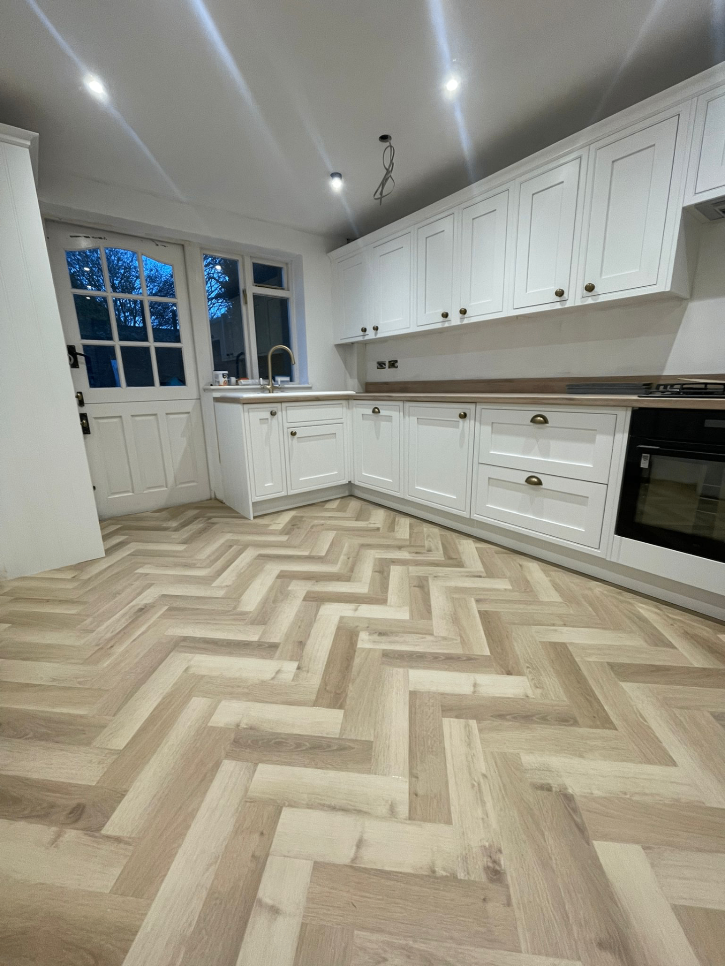 Herringbone LVT kitchen — wide view