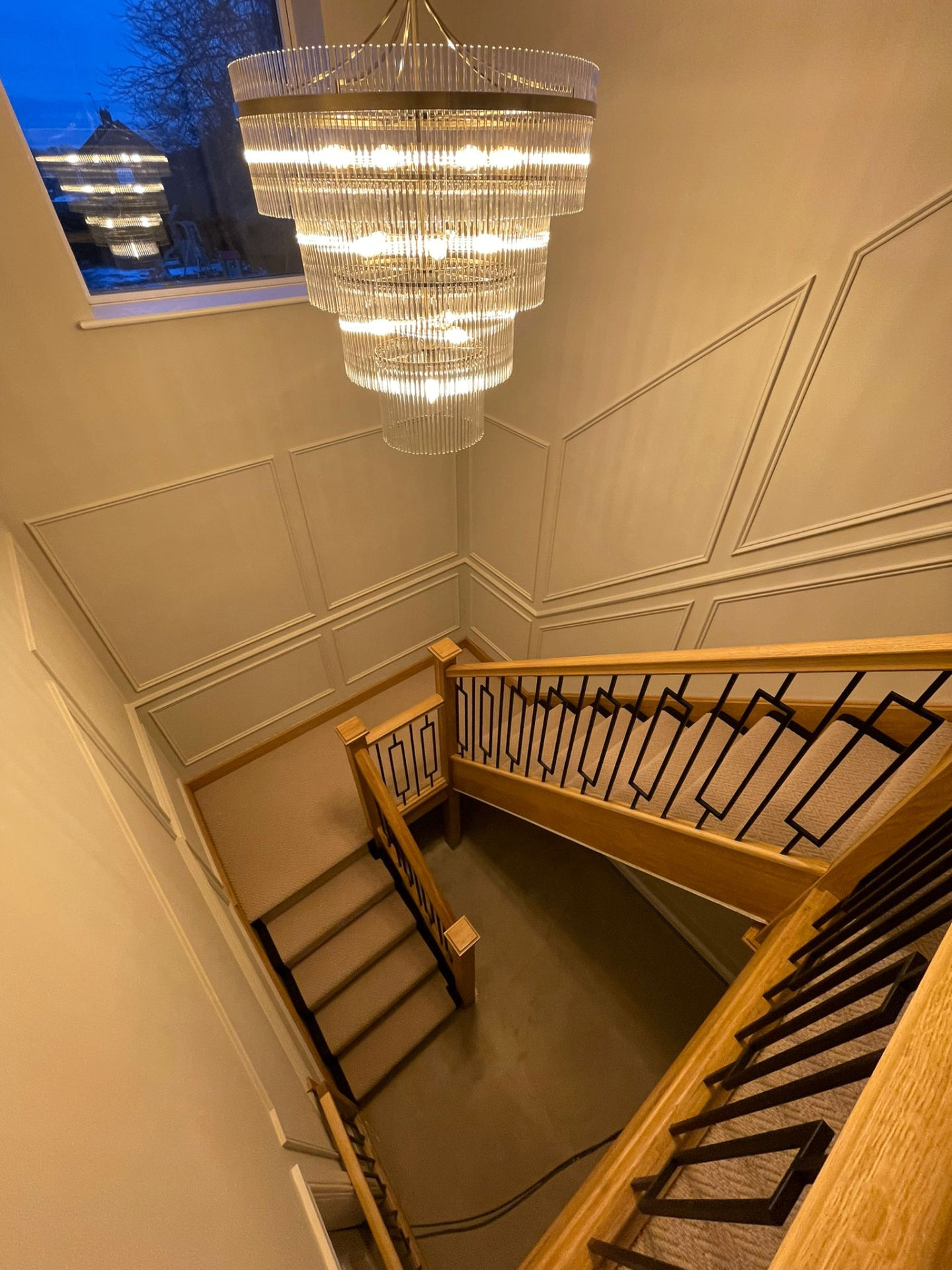 Stairwell runner with chandelier